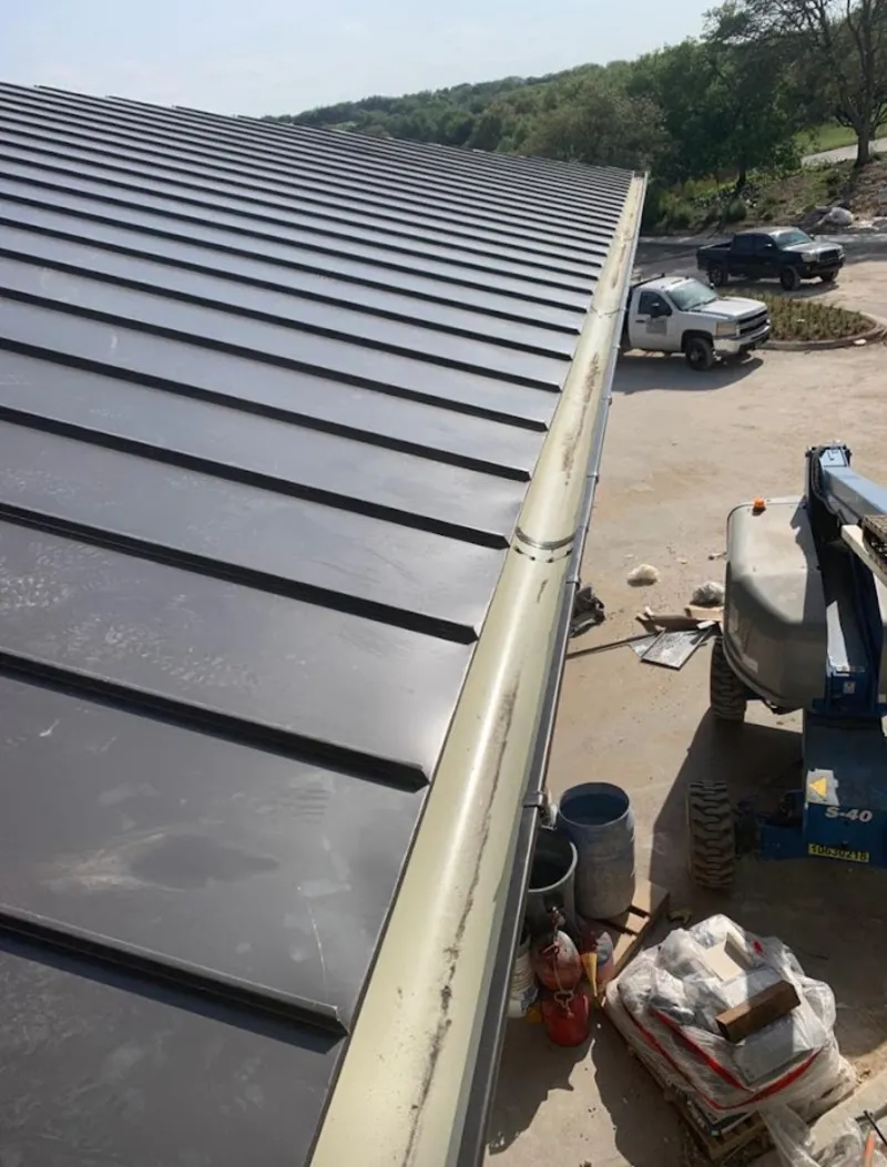 Standing seam panel and gutter detail on a metal roofing jobsite in Middle Smithfield